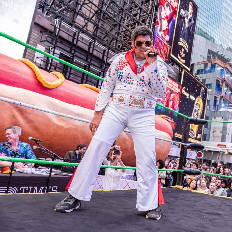 Elvis singing in the ring in Times Square at the Condiment Wars